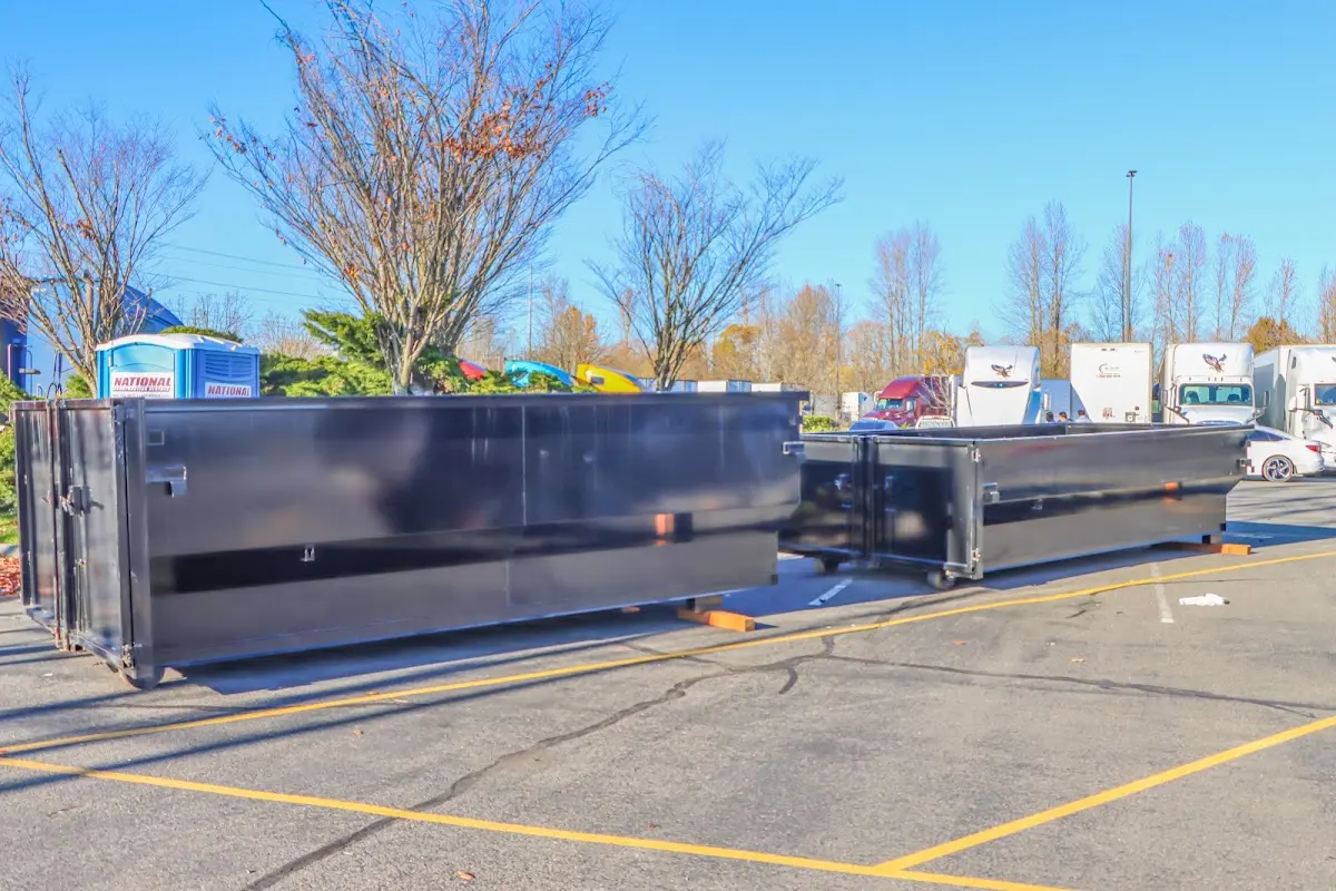 Professional dumpster rental service with roll-off container on residential driveway in Boonville